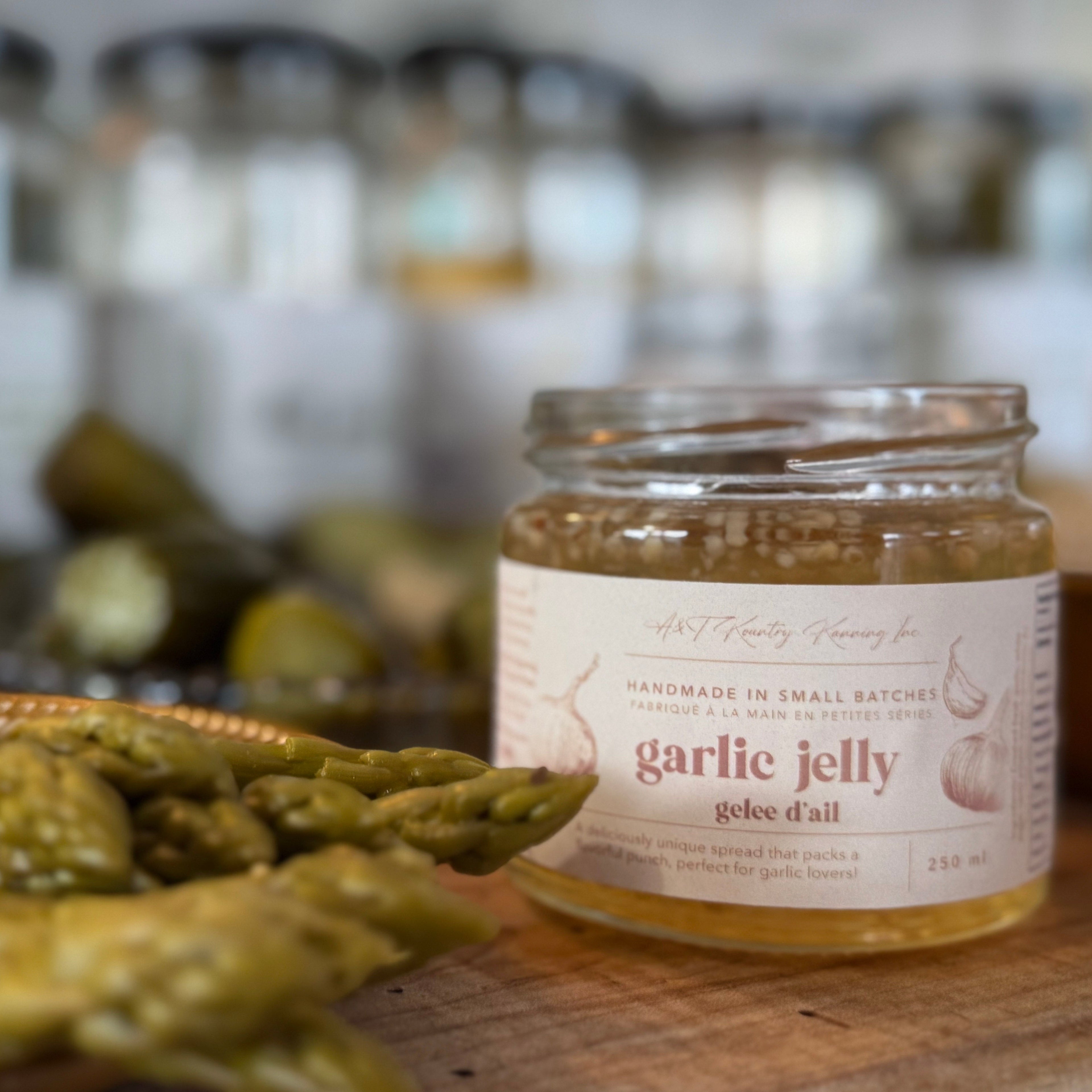 Jar of garlic jelly with asparagus on a wooden surface