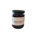 Jar of pickled beets with a label on a white background